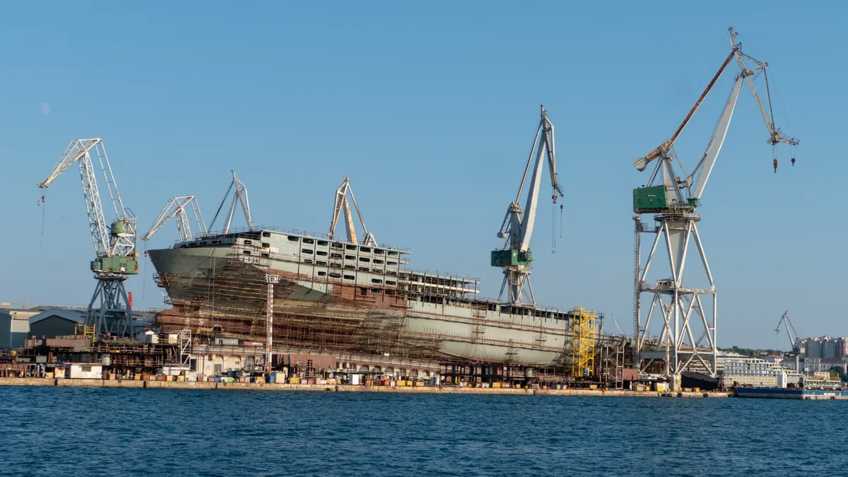 Shipbuilding yard with cranes and vessel